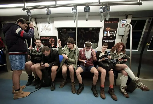 Passengers without pants sit inside a subway train during “The No Pants Subway Ride” in Bucharest January 11, 2015. (Photo by Radu Sigheti/Reuters)