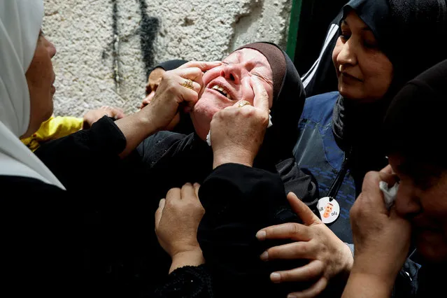 The mother of one of three Palestinian militants, who were killed in an Israeli raid, reacts during their funeral in Balata camp, Nablus, in the Israeli-occupied West Bank on May 22, 2023. (Photo by Raneen Sawafta/Reuters)