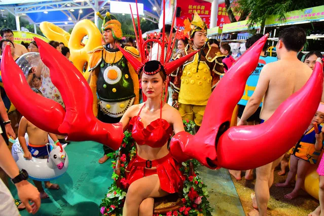 A performer dressed as a lobster is seen during a lobster-themed electronic music party at a water park on August 01, 2020 in Hangzhou, Zhejiang Province of China. (Photo by Lian Guoqing/VCG via Getty Images)