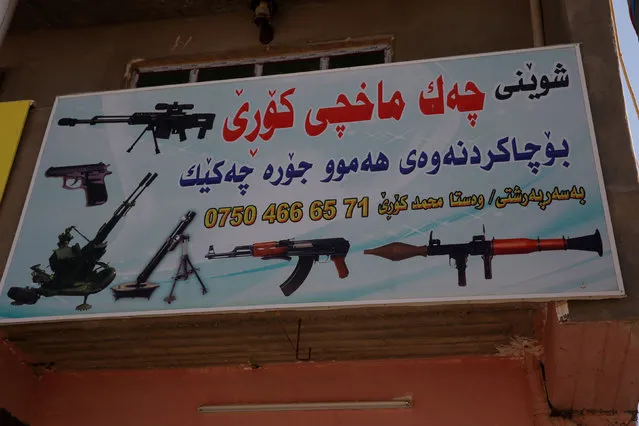 A sign is read (Korre's gunsmith for repairs of all sorts of weapons, run by master Mohammed Korre)in the shop of Mohammed Fadil outside of Erbil, Iraq November 6, 2016.  Picture taken November 6, 2016. (Photo by Marius Bosch/Reuters)