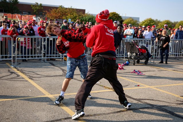 Vendors fight outside a rally for Republican presidential nominee and former U.S. President Donald Trump in Saginaw, Michigan, U.S., October 3, 2024. (Photo by Brendan McDermid/Reuters)
