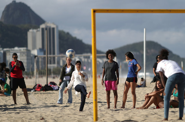 Nobel prize winner Malala Yousafzai plays a penalty kick during a meeting with teenage girls from Complexo da Penha who work with football organization Street Child United at Copacabana beach in Rio de Janeiro, Brazil July 11, 2018. (Photo by Ricardo Moraes/Reuters)