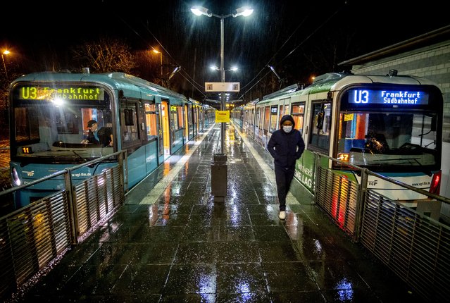 A man wearing a face mask has left a train at a subway station in Oberursel near Frankfurt, Germany, on early Monday, March 15, 2021. Numbers of Corona infections in Germany are rising again. (Photo by Michael Probst/AP Photo)