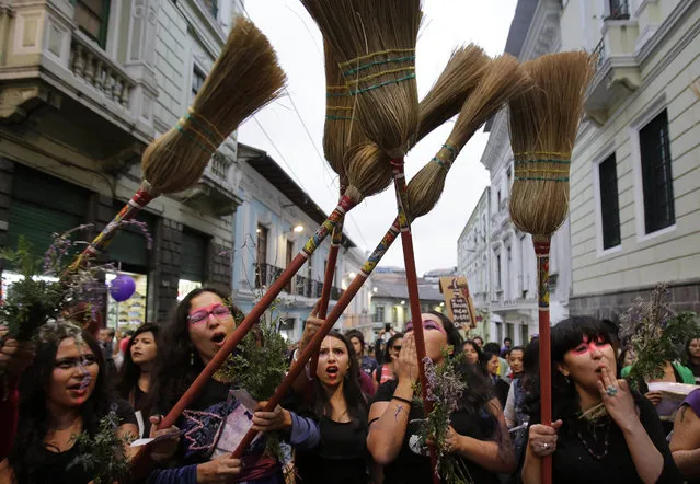 Women hold brooms in the air during a march, called by feminist organizations, against gender violence in Quito, Ecuador, Saturday, November 26, 2016. According to Ecuador's attorney general's office, 188 women have been killed from 2015 to the present. (Photo by Dolores Ochoa/AP Photo)