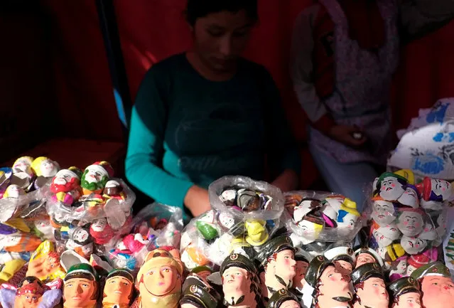 A vendor offers masks of “T'antawawas” (children's bread) to commemorate All Saints Day in La Paz, October 30, 2016. (Photo by David Mercado/Reuters)