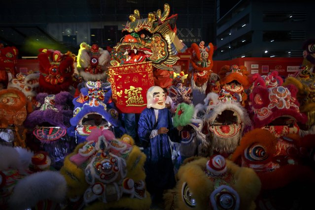 Lion and dragon dancers perform as part of the festive Chinese New Year celebrations in Bangkok's shopping district February 18, 2015. (Photo by Athit Perawongmetha/Reuters)