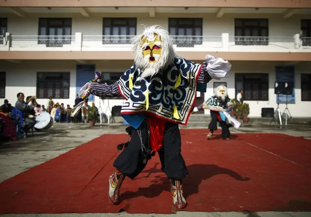 A Tibetan man performs traditional mask dance in front of the guests during the function organised to mark Losar or the Tibetan New Year at Tibetan Refugee Camp in Lalitpur February 19, 2015. (Photo by Navesh Chitrakar/Reuters)