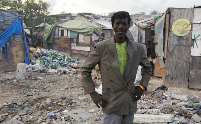 In this August 30, 2018 photo, Wilfrid Jocelyn, a 52-year-old trash scavenger, poses for a portrait near his home on the edge of the Truitier landfill in the Cite Soleil slum of Port-au-Prince, Haiti. The Central Bank estimates inflation in Haiti at around 16 percent a year, a spiraling cost of living which resonates painfully. (Photo by Dieu Nalio Chery/AP Photo)