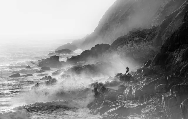 Fisherman on rocks in strong westerly winds, Porth Nanven, Cornwall, by Mick Blakey: “I hoped to photograph a serene sunset – but was in for a shock. There had been strong winds, which resulted in a big Atlantic swell. Initially disappointed, I started to notice spray around the cliffs as the waves were breaking – backlit by the sun. I sat happily on the rocks photographing the waves but then the magic happened … a fisherman appeared in frame”. Living the view, adult class – winner. (Photo by Mick Blakey/Landscape Photographer of the Year)