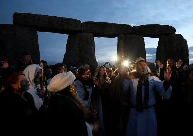 Visitors and revellers react amongst the prehistoric stones of the Stonehenge monument at dawn on Winter Solstice, the shortest day of the year, near Amesbury in south west Britain, December 21, 2016. (Photo by Toby Melville/Reuters)
