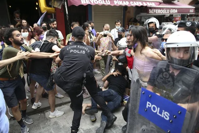 Protesters are detained by police in central Istanbul, Saturday, June 26, 2021. Police used tear gas to disperse the crowds and detained dozens of LGTBI activists as hundreds defied a ban and tried to stage a gay pride event. (Photo by Emrah Gurel/AP Photo)