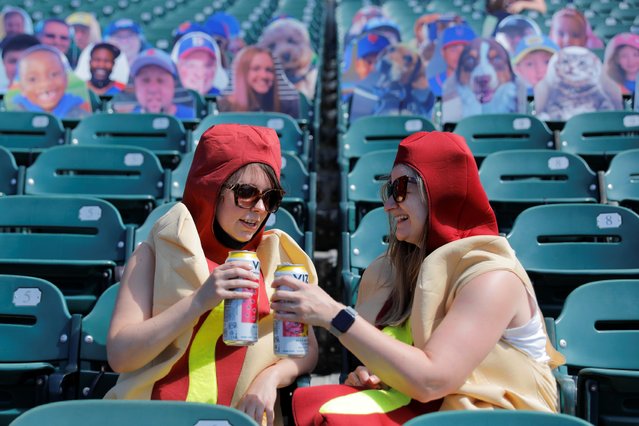 People dressed as hot dogs drink beer in the stands at the Nathan's Famous Fourth of July Hot Dog-Eating Contest held at Maimonides Park in New York City, New York, U.S., July 4, 2021. (Photo by Andrew Kelly/Reuters)