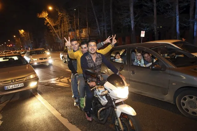 Iranians celebrate on a street in northern Tehran, Iran, Thursday, April 2, 2015, after Iran's nuclear agreement with world powers in Lausanne, Switzerland. (Photo by Vahid Salemi/AP Photo)