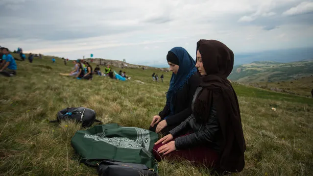 Young Crimean Tatars pray on the slopes of the Chatyr-Dah mountains in Crimea on May 13, 2018. More than 1,000 people commemorated the victims of the deportation of Crimean Tatars from their homeland during the rule of Soviet dictator Josef Stalin in 1944. (Photo by Radio Free Europe/Radio Liberty)