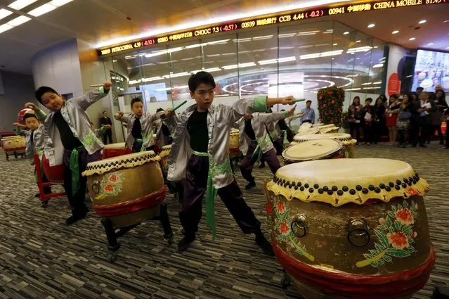 Schoolchildren play drums during a ceremony to mark the first day of trading after Lunar New Year holidays at the Hong Kong Stocks Exchange in Hong Kong, China February 11, 2016. (Photo by Bobby Yip/Reuters)
