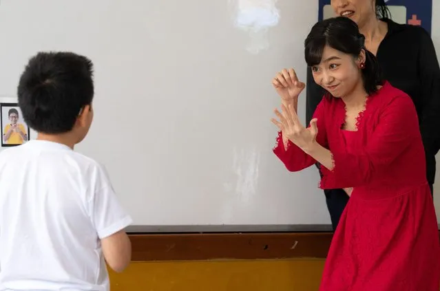 Japan's Princess Kako, daughter of Crown Prince Akishino (R), communicates in sign language with a student during a maths class during a visit to a special education school in Lima on November 6, 2023. Princess Kako of Japan, niece of Emperor Naruhito, is on a six-day official visit to Peru as part of the 150 years of the establishment of diplomatic ties between the Asian nation and the Latin American country. (Photo by Cris Bouroncle/AFP Photo)