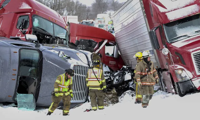 Emergency personnel work at the scene of a crash near Fredericksburg, Pa., Saturday, February 13, 2016. State police say a pileup has closed Interstate 78 in central Pennsylvania. (Photo by Daniel Zampogna/PennLive.com via AP Photo)
