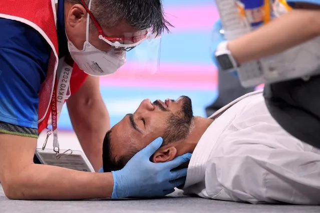 Abdalla Abdelaziz of Egypt receives medical attention during his men's karate 75kg kumite match against Ken Nishimura of Japan during the Tokyo 2020 Olympic Games at the Nippon Budokan in Tokyo on August 6, 2021. (Photo by Carl Recine/Reuters)