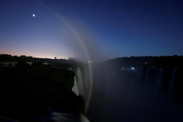 A rainbow is seen at the Iguazu Falls during a full moon known as the “Buck Moon”, on the Argentine side of the Iguazu River in Puerto Iguazu, Argentina on July 3, 2023. (Photo by Agustin Marcarian/Reuters)