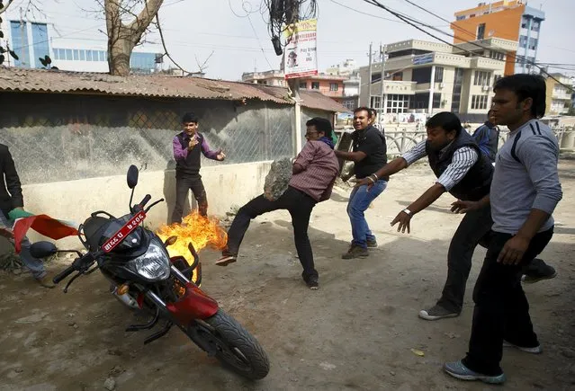 Protesters set a motorcycle alight during a nationwide strike, organised by the opposition alliance led by the Unified Communist Party of Nepal (Maoist) to demand the new constitution be drafted with the consensus of all political parties, in Kathmandu April 7, 2015. (Photo by Navesh Chitrakar/Reuters)