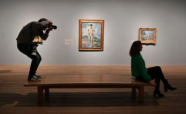 A photographer takes a photograph during the EY Exhibition; Cezanne at the Tate Modern in London, Britain, 03 October 2022. The Tate Modern is presenting the EY Exhibition: Cezanne from 05 October 2022 to 12 March 2023. (Photo by Andy Rain/EPA/EFE)