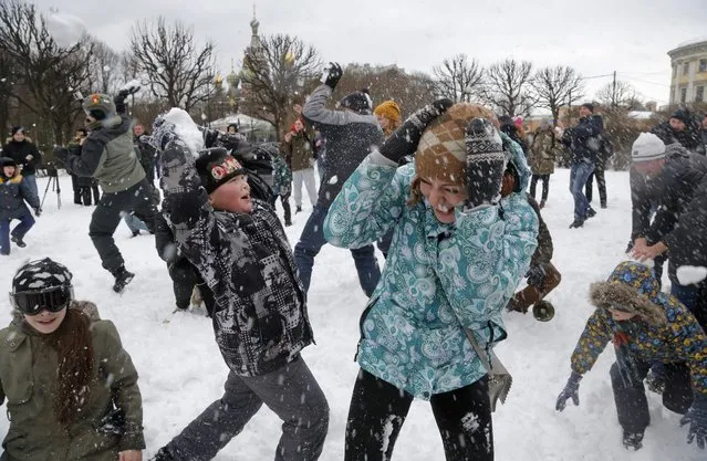 People throw snowballs during a snowball fight flashmob in St.Petersburg, Russia, Sunday, February 28, 2016. (Photo by Dmitri Lovetsky/AP Photo)