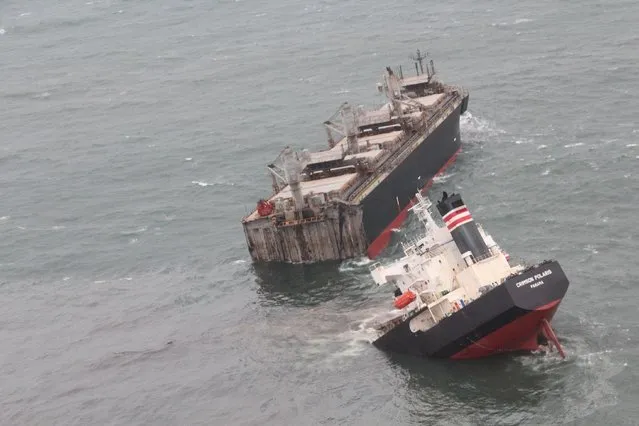 An aerial photo shows Panama-registered cargo ship Crimson Polaris (39,910 tons) which the hull broke off the coast of Hachinohe City, Aomori Prefecture, northern Japan, on August 12, 2021. At around 4:15 am on the same day, the cargo ship hit a rock and was broken in two, and its oil is leaking. All 21 crew members were rescued. The cargo ship loaded wood chips and was heading from Thailand to Hachinohe Port. (Photo by Japan Coast Guard via Reuters)