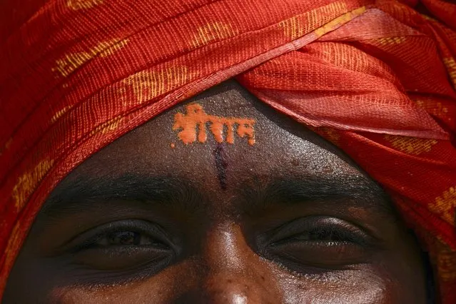 A Hindu devotee has the words Sri Ram' written on his forehead as he watches in Hyderabad, India, a live telecast of inauguration of a temple dedicated to the Hindu Lord Ram in northern Ayodhya town, Monday, January 22, 2024. Indian Prime Minister Narendra Modi on Monday opened a controversial Hindu temple built on the ruins of a historic mosque in the holy city of Ayodhya in a grand event that is expected to galvanize Hindu voters in upcoming elections. (Photo by Mahesh Kumar A./AP Photo)