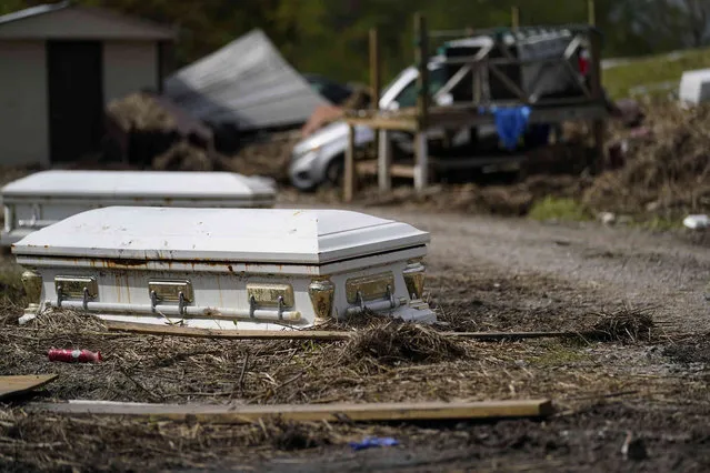 Displaced caskets that floated away from a cemetery during flooding sits along a road in Ironton, La., Monday, September 27, 2021. A month after Hurricane Ida, small communities along Louisiana's southeastern coast are still without power or running water. Some residents have lost most of their possessions to the storm's floodwaters. (Photo by Gerald Herbert/AP Photo)