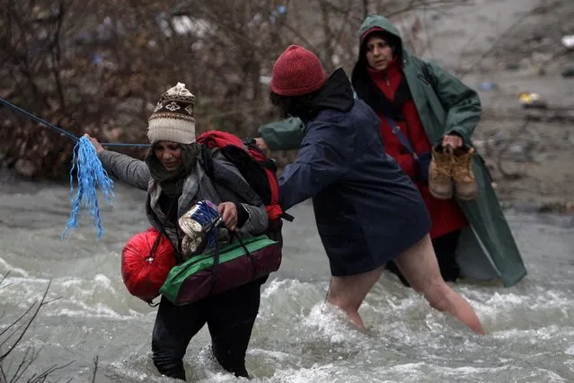 Refugees and migrants attempt to cross a river near the Greek-Macedonian border to enter Macedonia after an unsuccessful attempt yesterday, west of the village of Idomeni, Greece, March 15, 2016. (Photo by Alexandros Avramidis/Reuters)