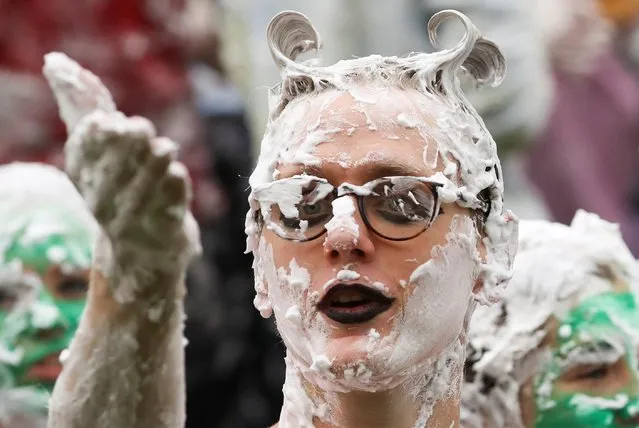 A student from St Andrews University is covered in foam as he takes part in the traditional “Raisin Weekend” in the Lower College Lawn, at St Andrews in Scotland, Britain on October 18, 2021. (Photo by Russell Cheyne/Reuters)