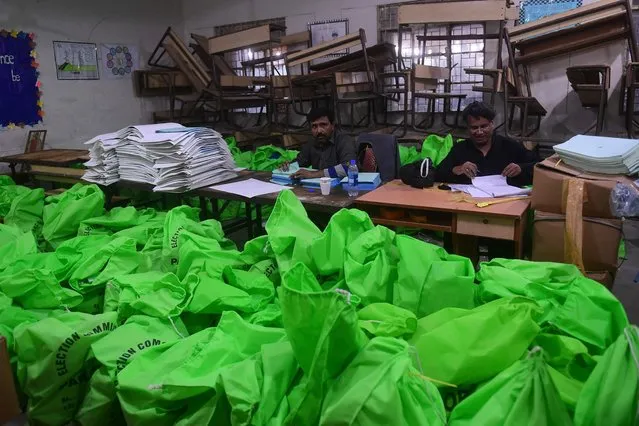 Pakistan election commission workers prepare election materials at a distribution center in Karachi on February 6, 2024, ahead of Pakistan's national elections. (Photo by Asif Hassan/AFP Photo)