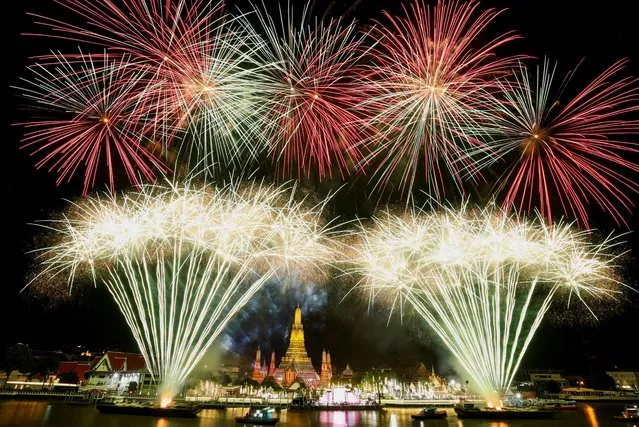 Fireworks explode over the Chao Phraya River during the New Year celebrations, in Bangkok, Thailand on January 1, 2023. (Photo by Athit Perawongmetha/Reuters)