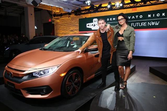 Musicians Nick Jonas and Demi Lovato pose with the 2017 Honda Civic Hatch at the Honda Civic Tour Artists Announcement and Honda Civic North America Launch Event at the Garage on March 22, 2016 in New York City. (Photo by Neilson Barnard/Getty Images)