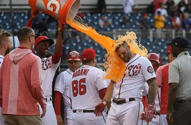 Nationals center fielder Michael A. Taylor, left, dumps Gatorade on teammate Matt Adams to celebrate his walk-off home run to win the game against the San Diego Padres at Nationals Park in Washington, D.C. on April 28, 2019. (Photo byToni L. Sandys/The Washington Post)