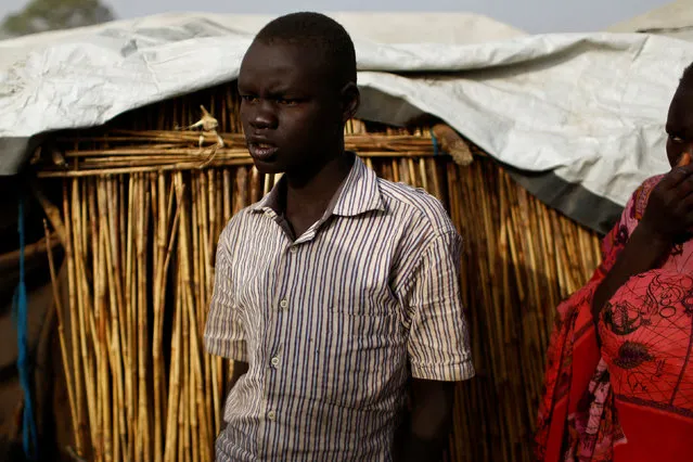Nhial Mario, 14, stands next to his home in the United Nations Mission in South Sudan (UNMISS) Protection of Civilian site (CoP), near Bentiu, South Sudan, February 13, 2017. (Photo by Siegfried Modola/Reuters)