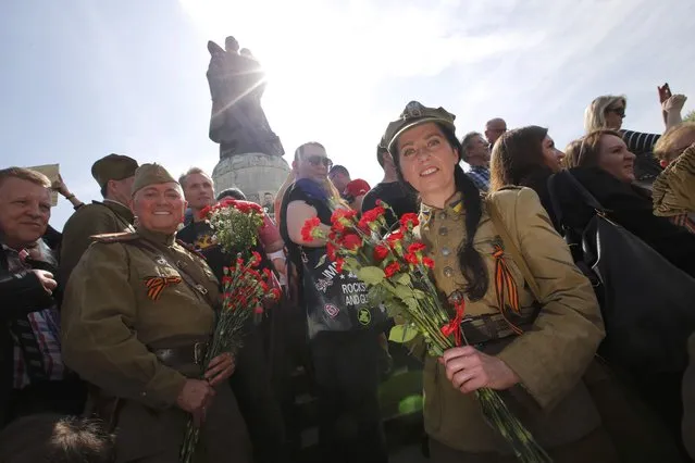 People wearing old uniforms take part in celebrations to mark Victory Day, at the Soviet War Memorial in Treptower Park in Berlin, Germany, May 9, 2015. (Photo by Fabrizio Bensch/Reuters)