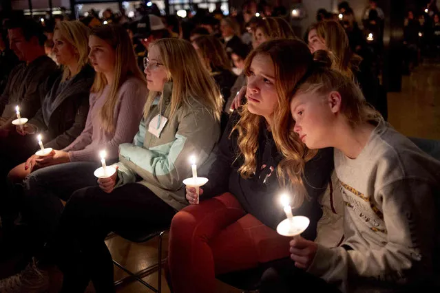 Emerson Miller, right, leans on her friend Joselyn's shoulder as they listen to Jessi Holt, pastor at LakePoint Community Church, during a prayer vigil at the church after the Oxford High School school shooting, Tuesday, November 30, 2021, in Oxford, Mich. (Photo by Jake May/The Flint Journal via AP Photo)