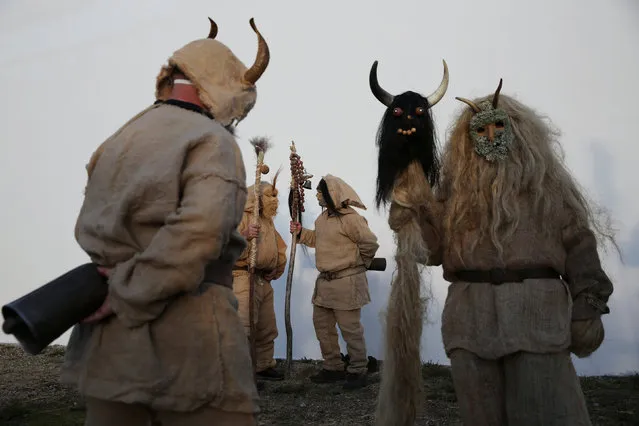 Revelers dressed as traditional carnival characters “Harramachos”, who wear cowbells, animal antlers and agricultural decor and are thought to ward off evil spirits and awaken the coming spring, take part in a carnival celebration in the village of Navalacruz, Spain, February 25, 2017. (Photo by Susana Vera/Reuters)