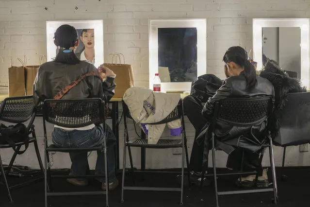 Models sit backstage after showing creations from Beautyberry by Yutao Wang during the China Fashion Week in Beijing, Saturday, March 30, 2024. (Photo by Tatan Syuflana/AP Photo)