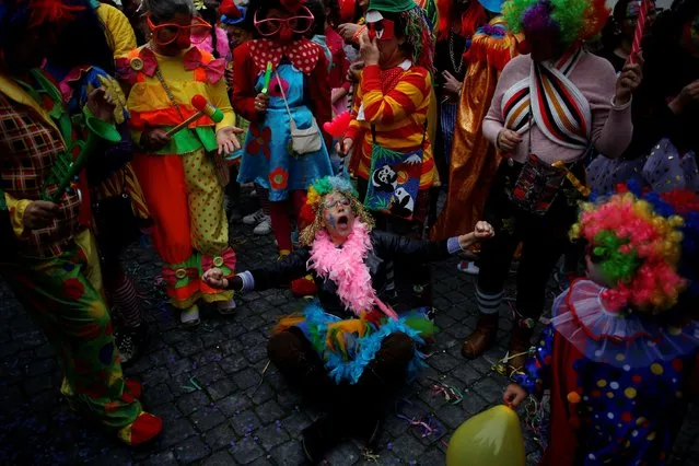 Carnival revellers participate in the clowns parade in Sesimbra village, Portugal, February 27, 2017. (Photo by Pedro Nunes/Reuters)