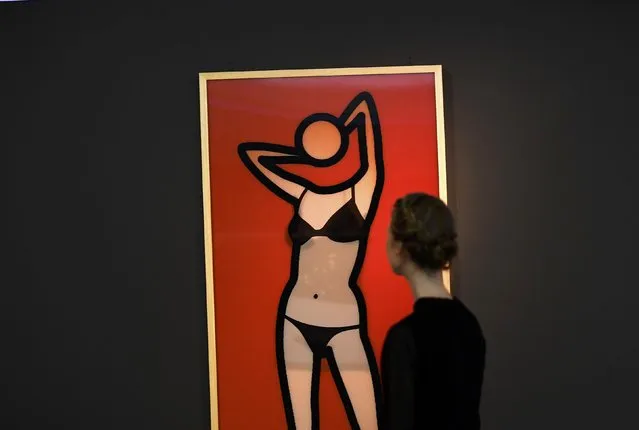 A museum worker poses as she looks at a lenticular print during a media event to promote “Undressed: A Brief History of Underwear” at the V&A Museum in London, Britain, April 12, 2016. The exhibition, which opens on Saturday, aims to tell the story of the changes in underwear design since the 18th Century. (Photo by Dylan Martinez/Reuters)