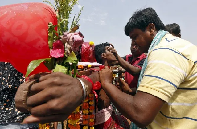 A Hindu devotee is nailed to a cross during the annual Shiva Gajan religious festival in Batanal village in West Bengal, India, April 13, 2016. (Photo by Rupak De Chowdhuri/Reuters)