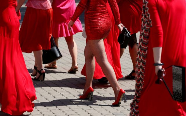 Participants of the “Lady in red“ procession, marking the day of the Summer Solstice, walk on a promenade of the Yenisei River in Krasnoyarsk, Russia on June 22, 2019. (Photo by Ilya Naymushin/Reuters)