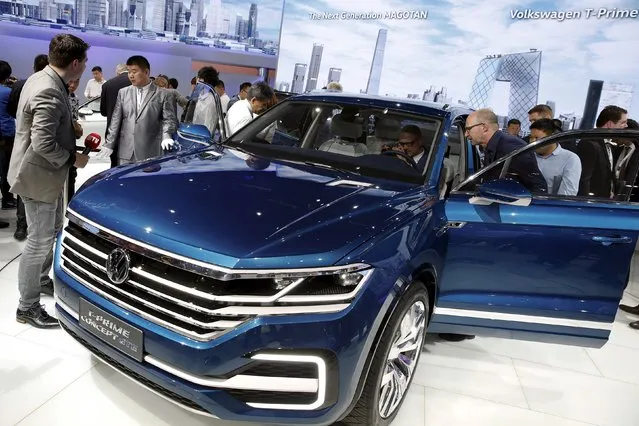 People gather around the Volkswagen's T-Prime Concept GTE hybrid SUV after it was presented during the Auto China 2016 auto show in Beijing April 25, 2016. (Photo by Damir Sagolj/Reuters)