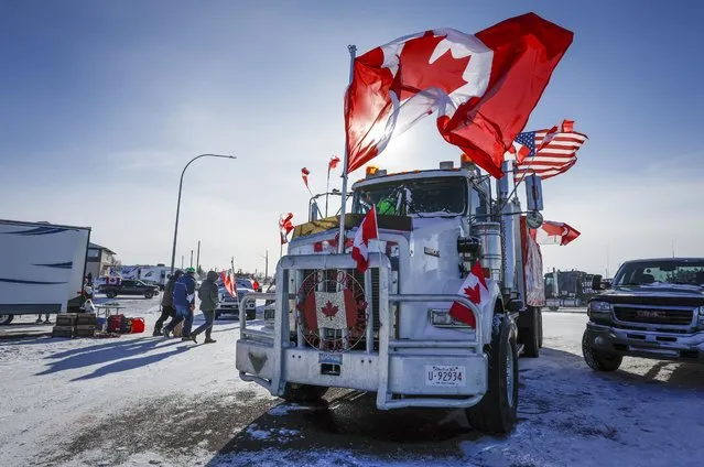 The last truck blocking the southbound lane moves after a breakthrough resolved the impasse where anti-COVID-19 vaccine mandate demonstrators blocked the highway at the busy U.S. border crossing in Coutts, Alberta, Wednesday, February 2, 2022. (Photo by Jeff McIntosh/The Canadian Press via AP Photo)