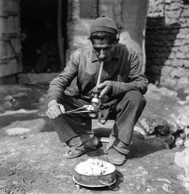 1955:  A man smoking opium in a village in Iran