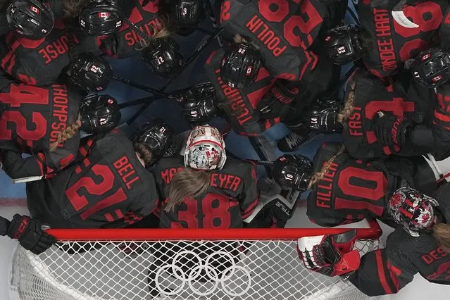 Canada's players huddle prior a women's quarterfinal hockey game between Canada and Sweden at the 2022 Winter Olympics, Friday, February 11, 2022, in Beijing. (Photo by Petr David Josek/AP Photo)