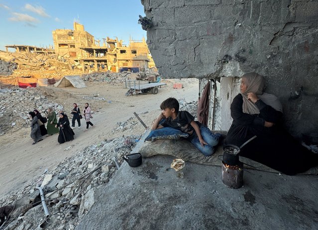 Palestinians sit at their house which was destroyed in an Israeli strike in Khan Younis, in the southern Gaza Strip on May 29, 2024. (Photo by Mohammed Salem/Reuters)