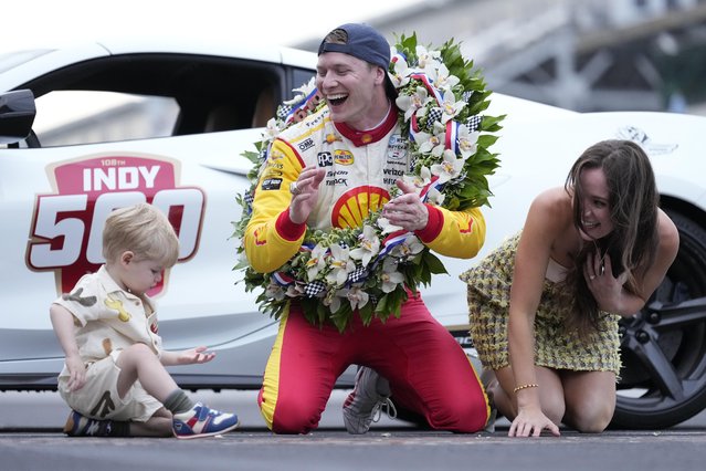 Josef Newgarden, center, celebrates with his son Kota and wife Ashley Welch after winning the Indianapolis 500 auto race at Indianapolis Motor Speedway in Indianapolis, Sunday, May 26, 2024. (Photo by A.J. Mast/AP Photo)